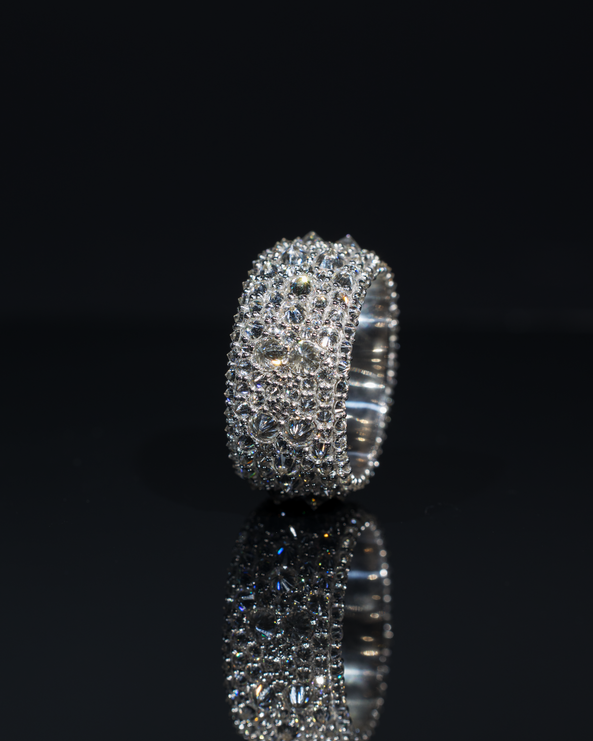 The Inverted Diamond Band with its reflection against a dark background