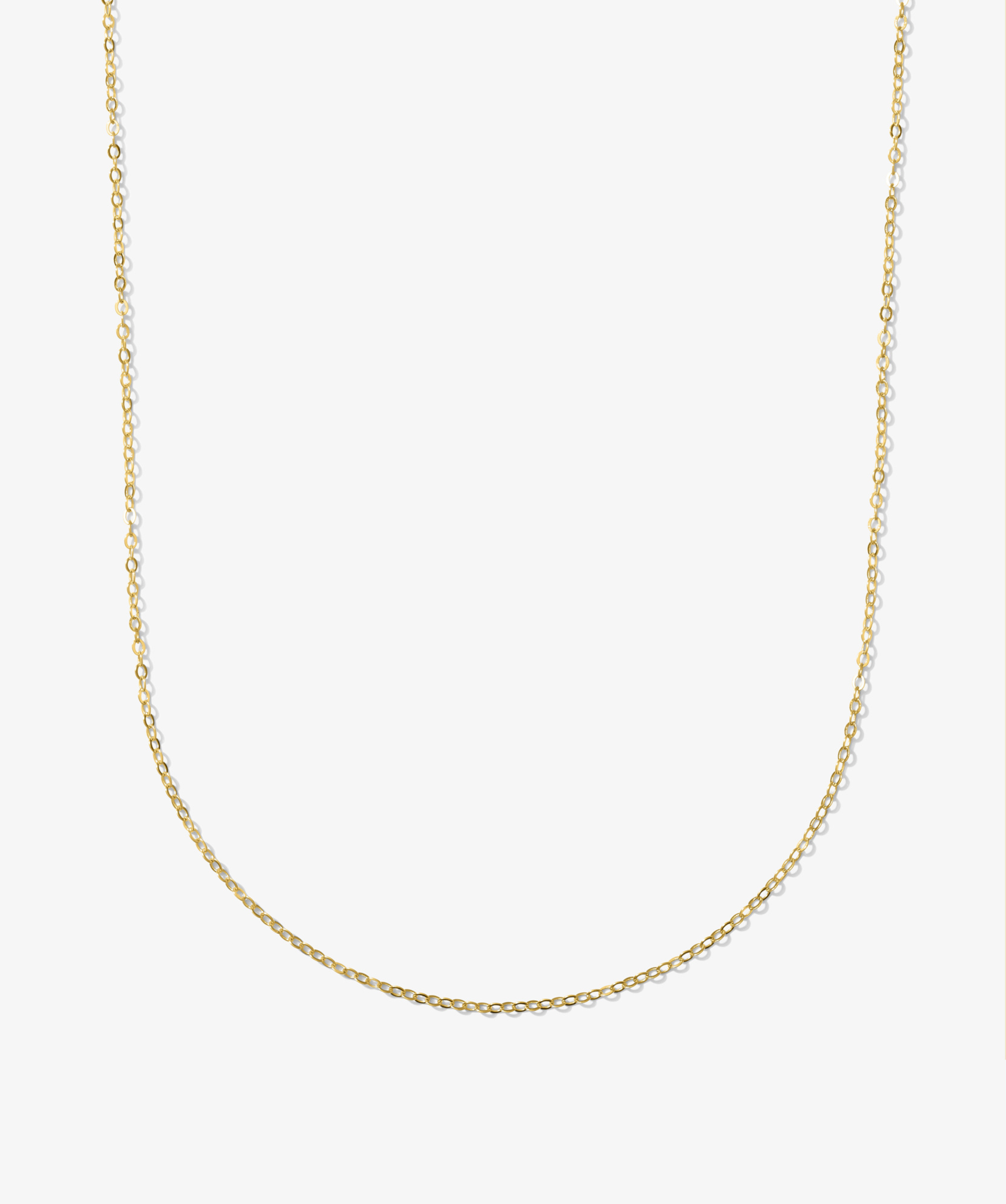 ICED London gold chain necklace with delicate curb links, minimalist jewelry on white background.