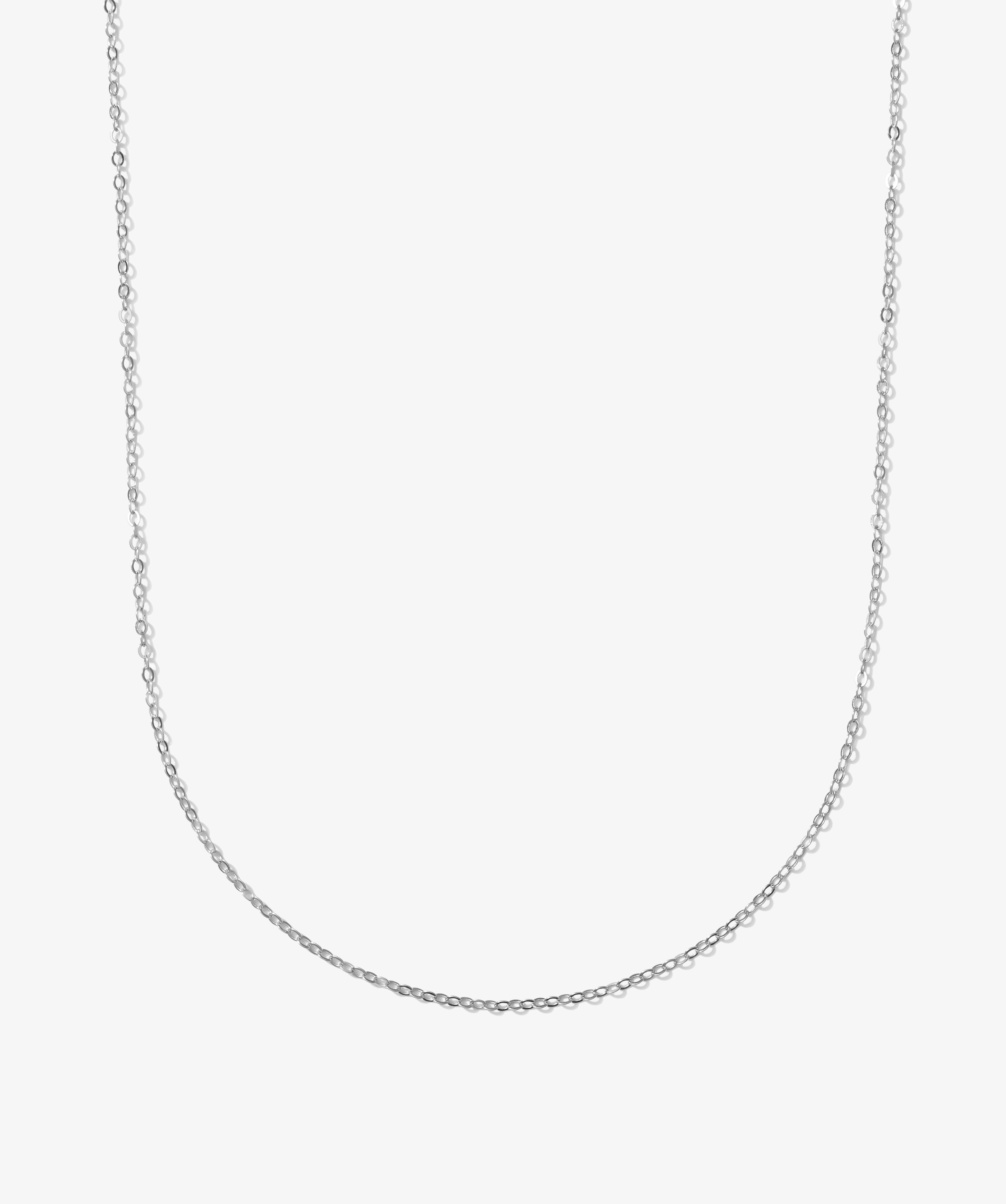ICED London silver chain necklace, delicate curb-link design, close-up view against white background.