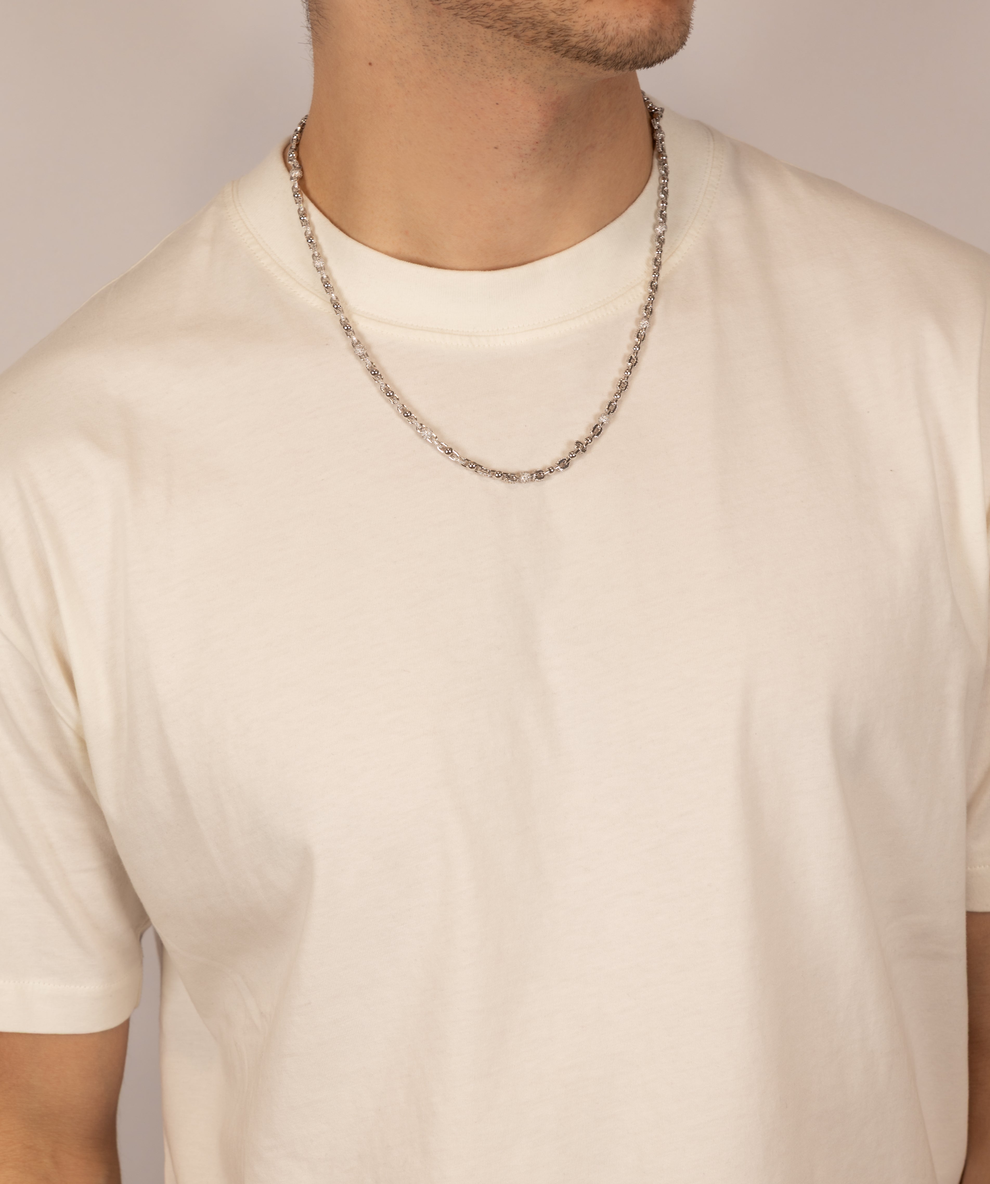 ICED London silver chain necklace worn by male model in a white crew-neck T-shirt.