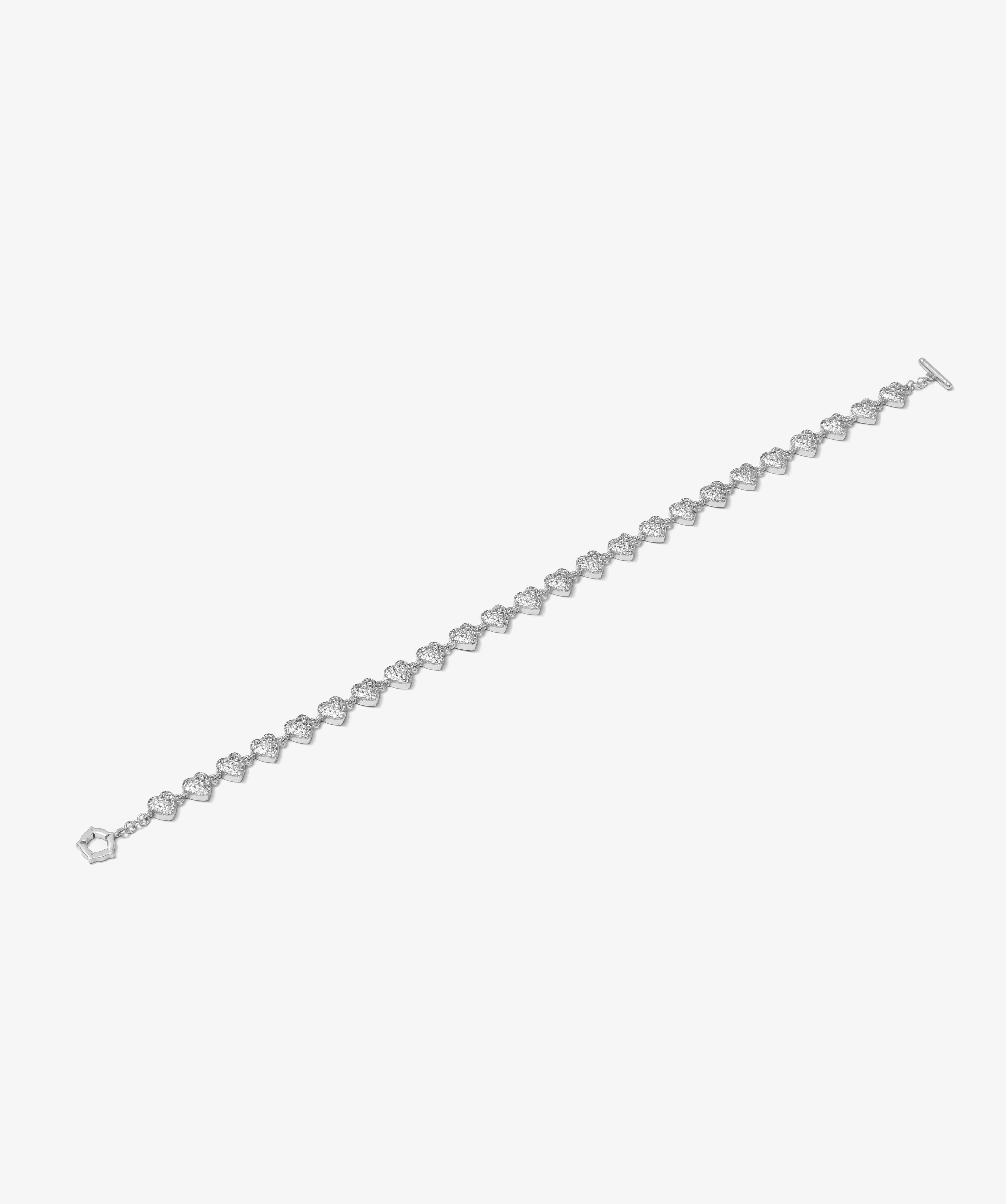 ICED London diamond tennis bracelet with heart-shaped links in silver, elegant jewelry against a white background.