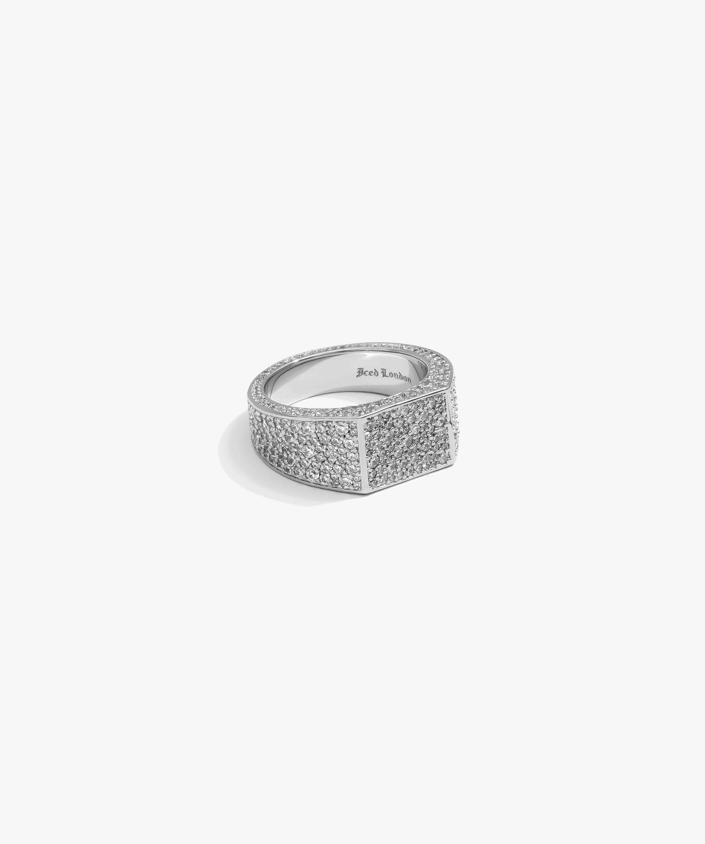 ICED London diamond‑encrusted wide band ring with pavé stones on silver metal against white background.