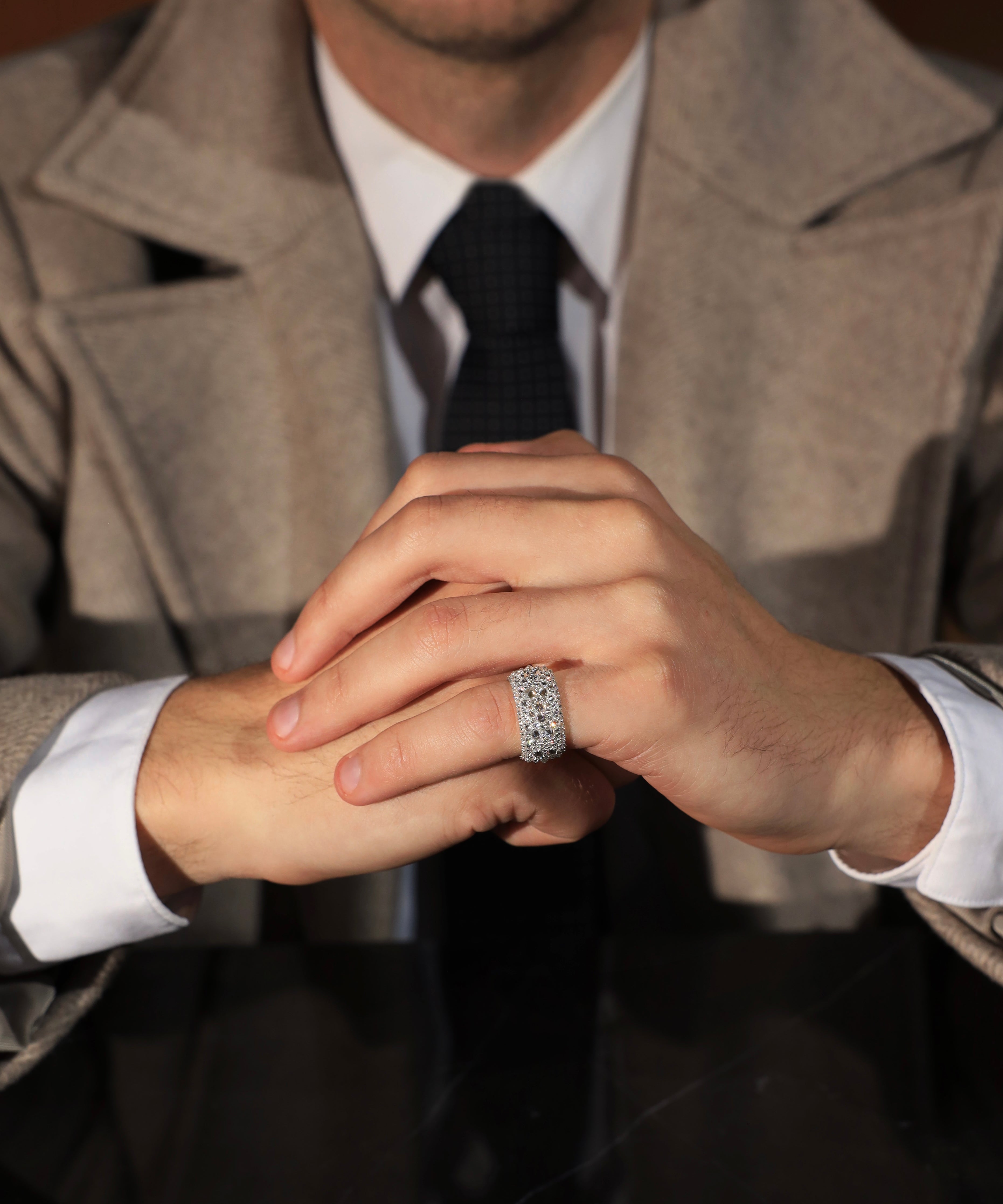 The Inverted Diamond Band worn on the little finger with tailored outerwear