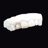 ICED London gold diamond-encrusted dental hoop on a white dental model (front view of teeth).