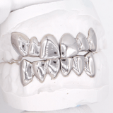 Silver dental grills (grillz) on a plaster dental model, ICED London.
