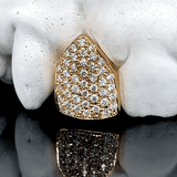 ICED London gold shield-shaped pendant with pavé diamonds, diamond-encrusted Jewelry, reflected on glossy surface.