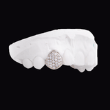 ICED London teardrop pave-diamond pendant placed on a white dental impression mold for jewelry and dental showcase.