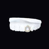 ICED London: white dental model featuring a teardrop-shaped diamond halo pendant embedded on the front tooth.