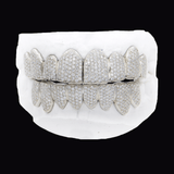 ICED London diamond-pavé grill set on a white dental mold, front view of upper and lower grills for teeth.